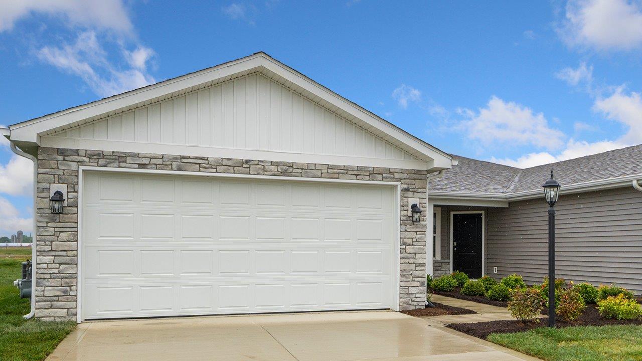 livingston lakes olsen exterior with 2 car garage, landscaping, sod, and covered front patio