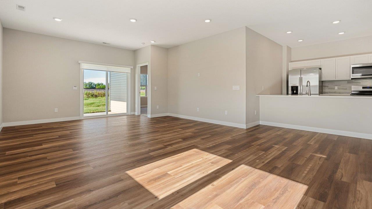 livingston lakes paired villas olsen open layout living room with mohawk luxury vinyl plank flooring and natural lighting