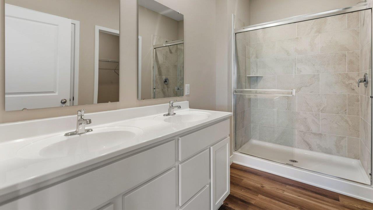 livingston lakes paired villas olsen primary ensuite bathroom with dual sink vanity and tile walk in shower