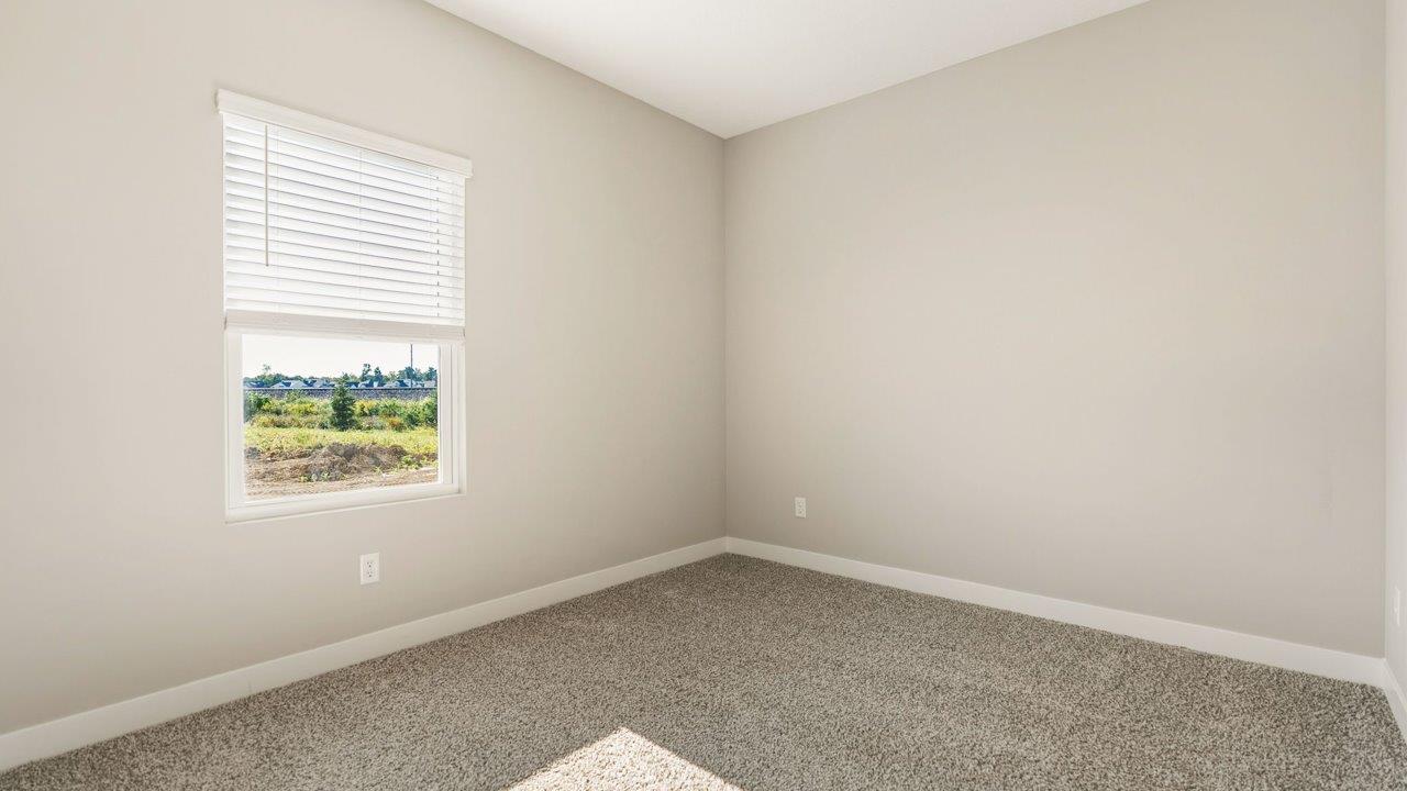 livingston lakes paired villas olsen bedroom 2 with beige carpet, ensuite closet, and single window