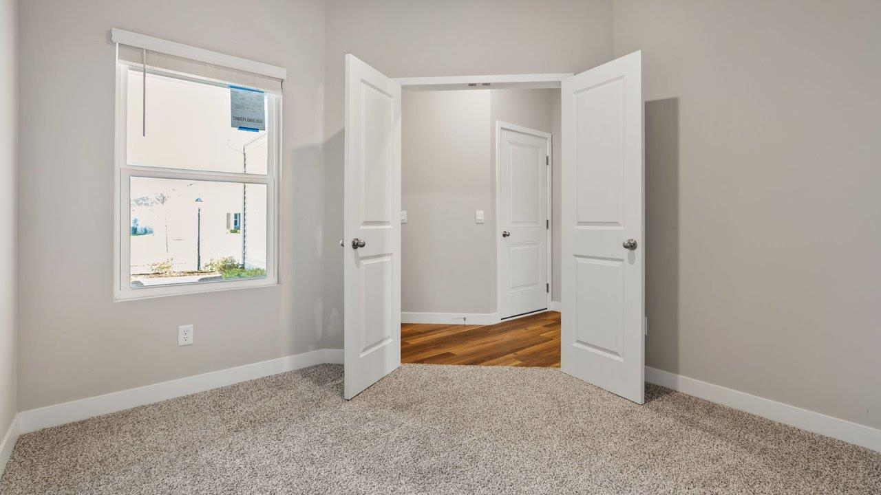 livingston lakes paired villas olsen flex room with french doors and beige carpet