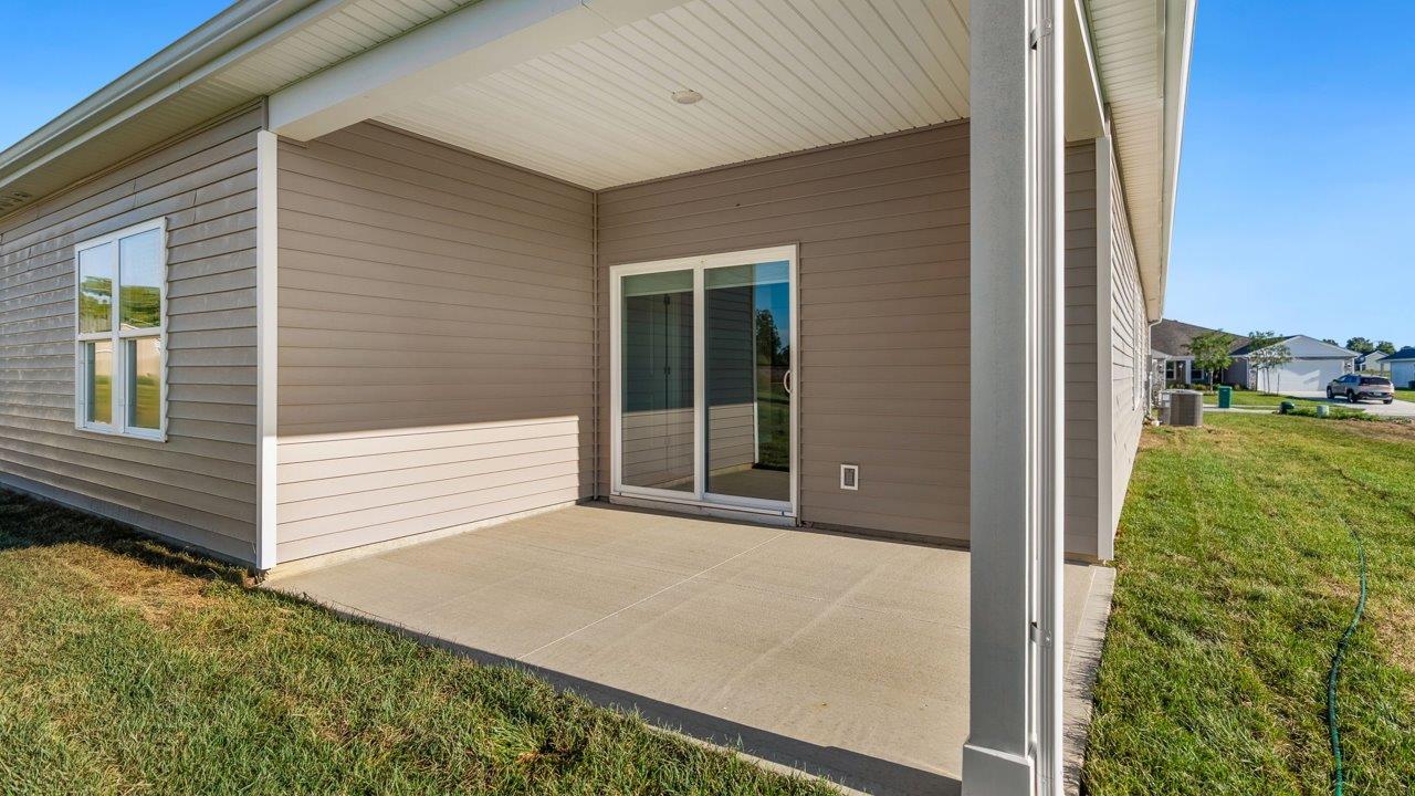 livingston lakes paired villas olsen backyard covered patio with sliding glass door and sodded yard