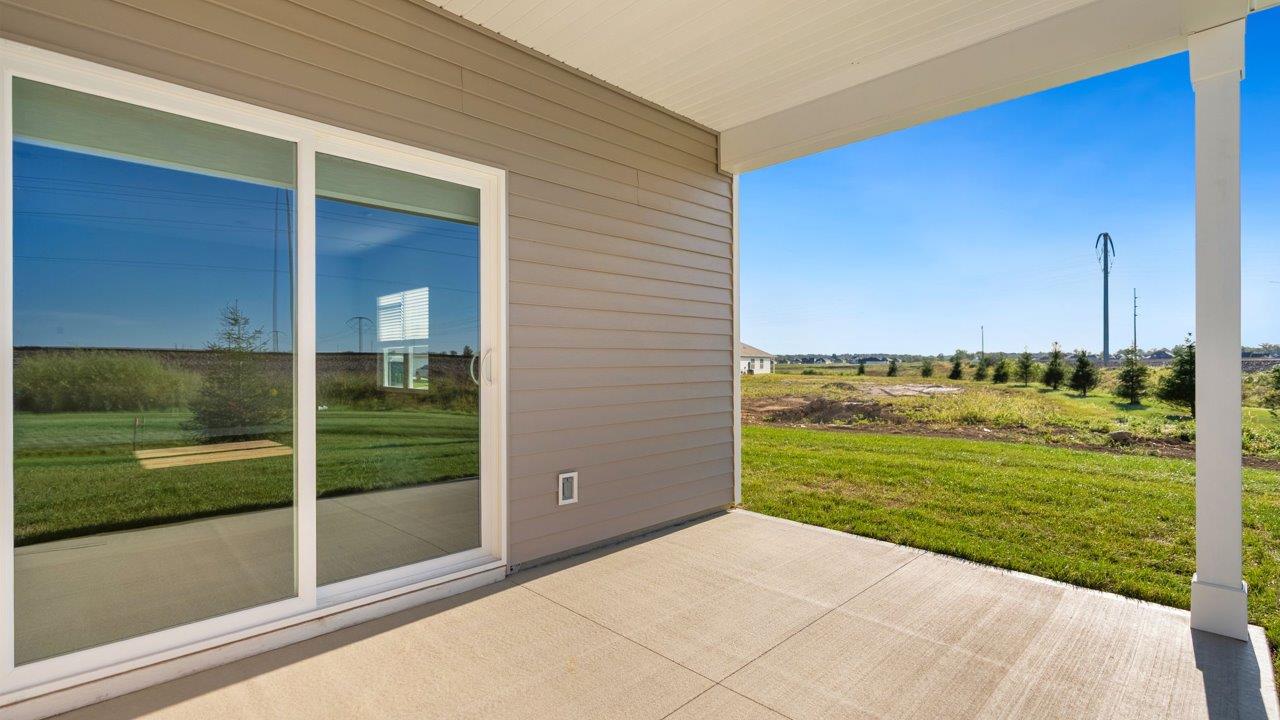 livingston lakes paired villas olsen backyard covered patio with sliding glass door and sodded yard