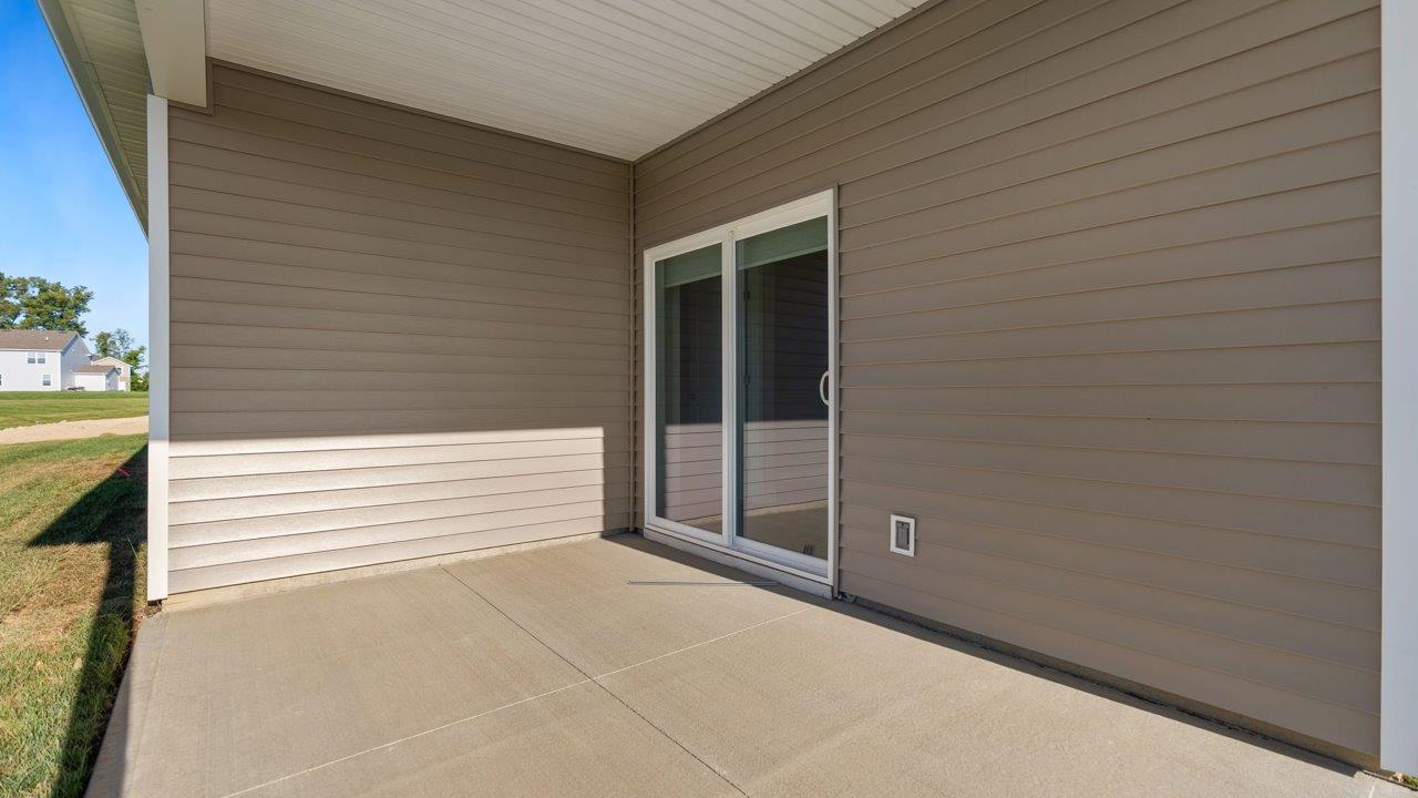 livingston lakes paired villas olsen backyard covered patio with sliding glass door and sodded yard