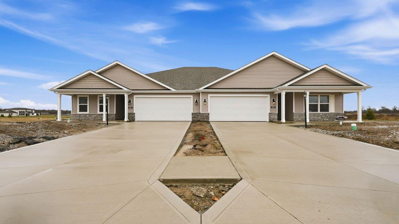 livingston lakes paired villa erie plan elevation b exterior with covered front porch and 2 car garage