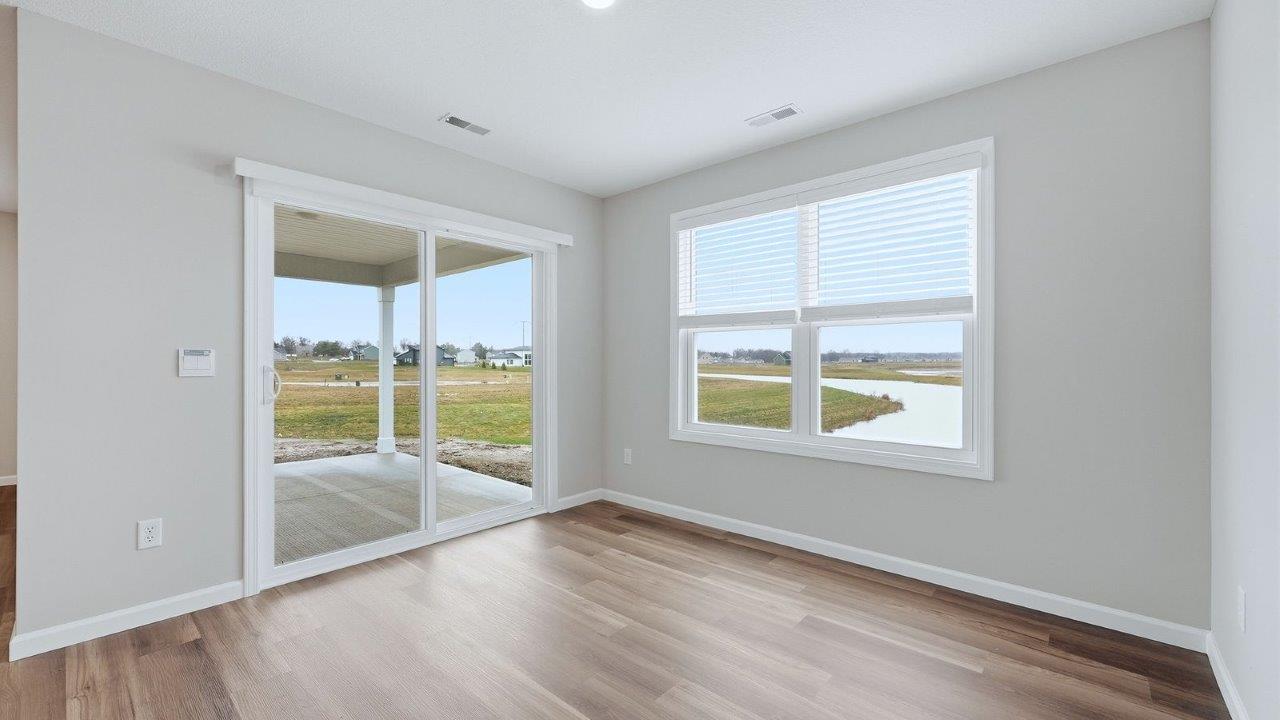 dining room with mohawk eastmont lvp flooring and sliding glass door to backyard covered patio