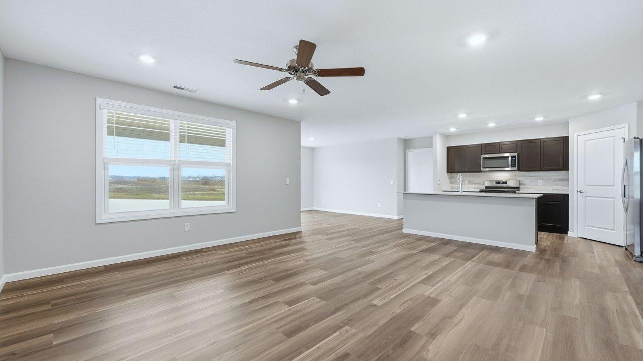 living room with mohawk eastmont lvp flooring, ceiling fan, and popular grey walls