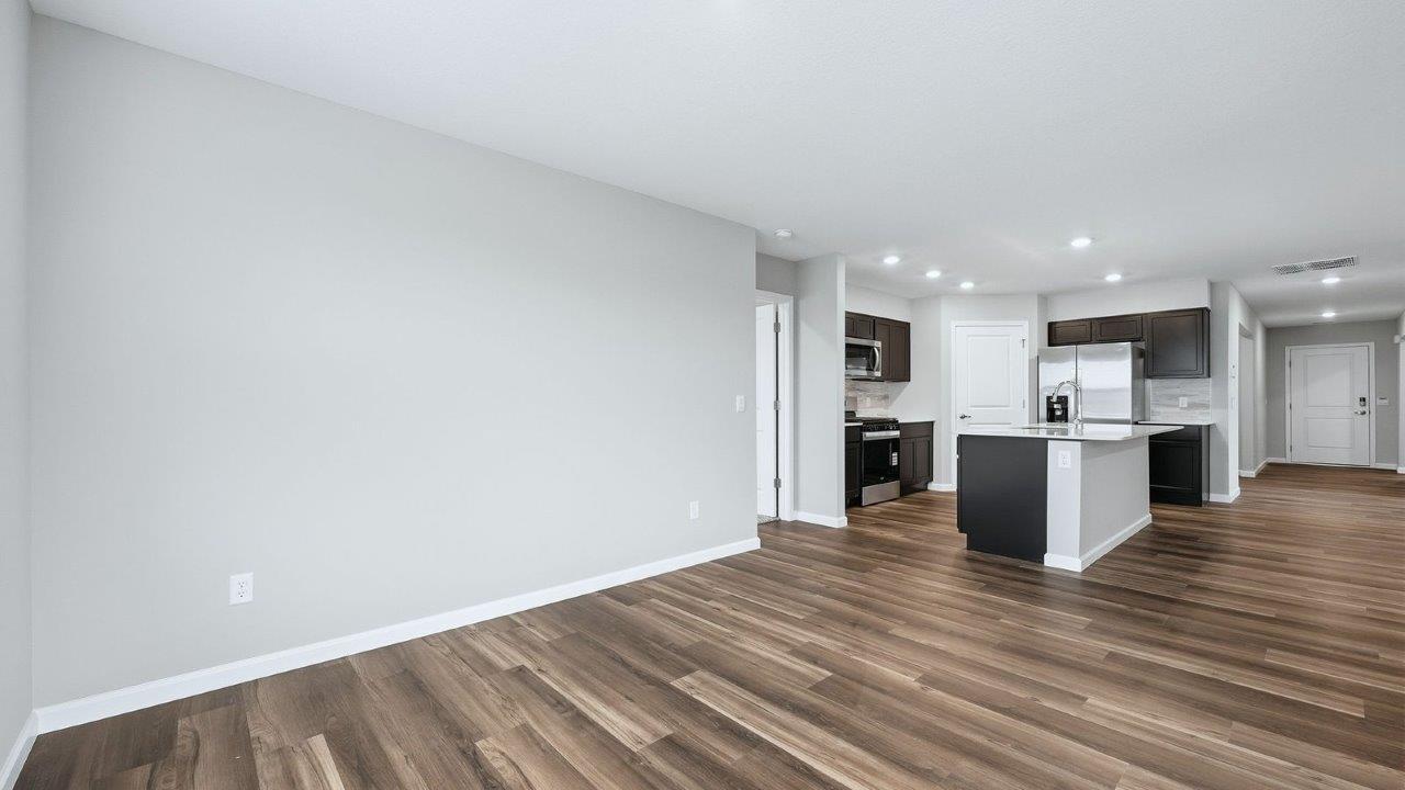 dining room with mohawk eastmont lvp flooring and sliding glass door to backyard covered patio