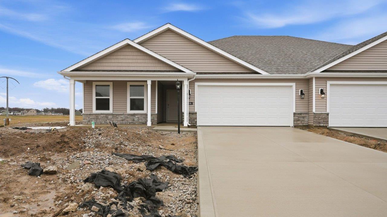 livingston lakes paired villa erie plan elevation b exterior with covered front porch and 2 car garage