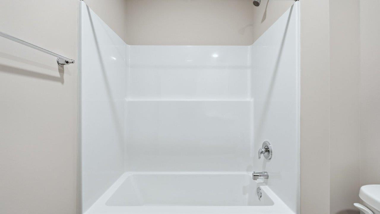 full bathroom single vanity sink with sarsaparilla cabinets and tub shower