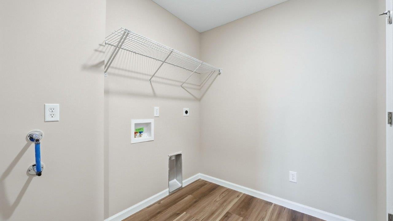 laundry room with lvp flooring and built-in shelving