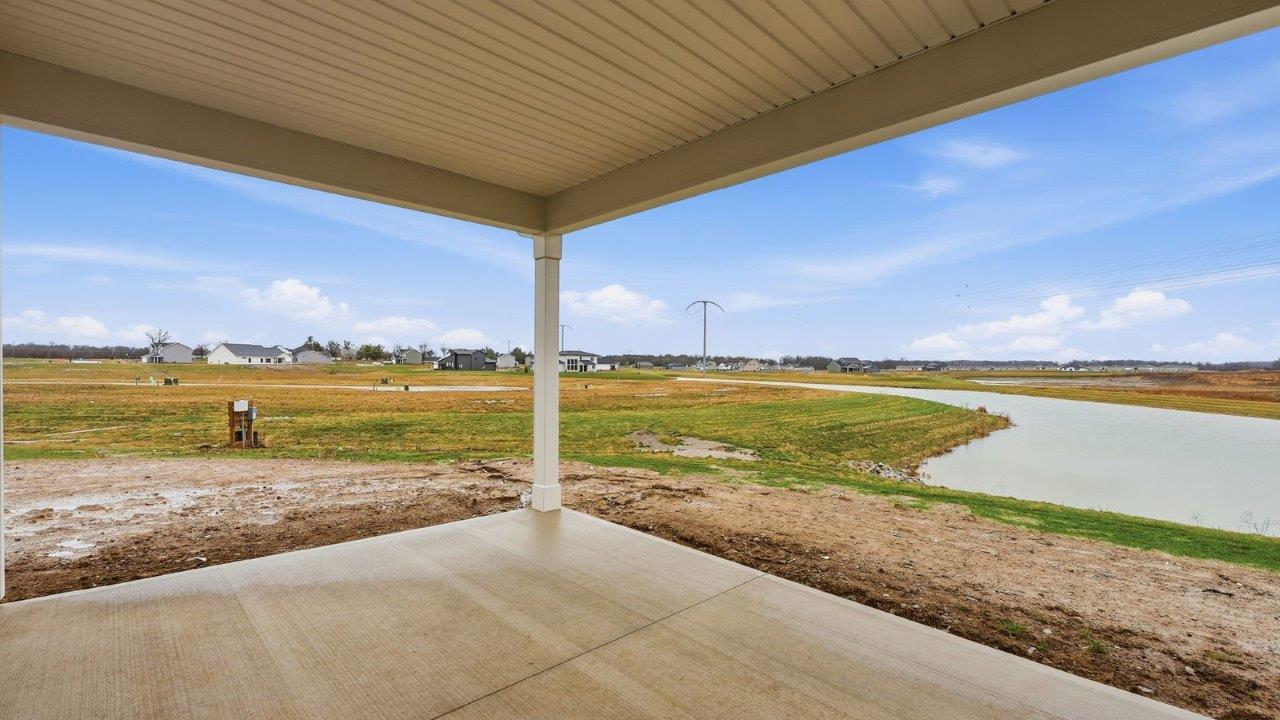 rear exterior with covered patio and pond view