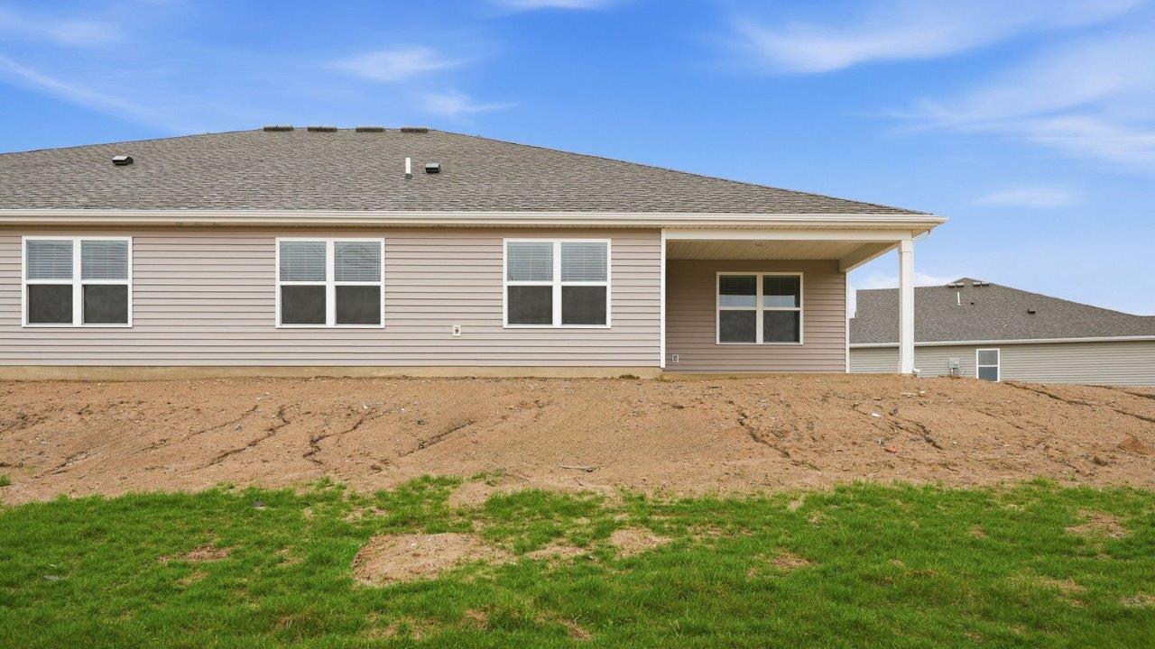 rear exterior with covered patio and pond view
