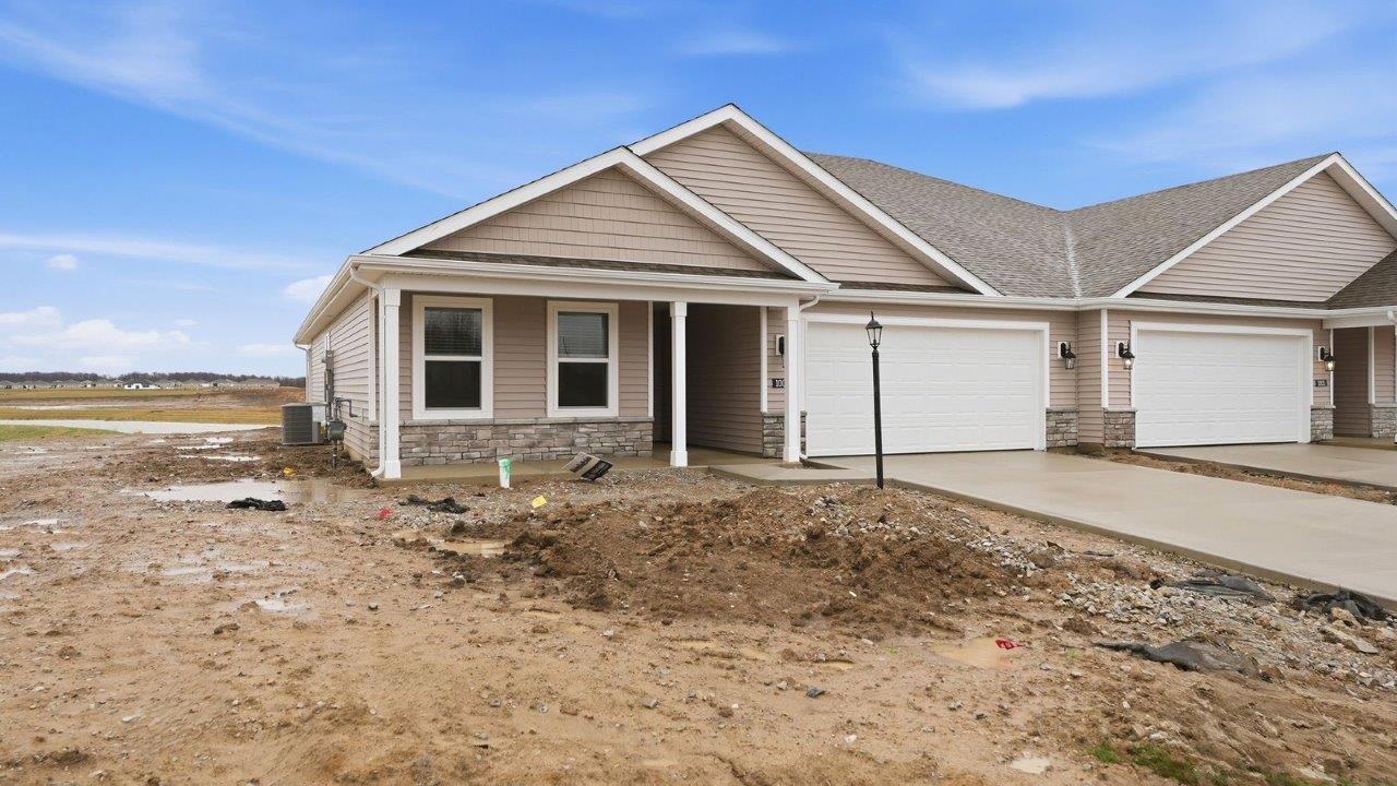 livingston lakes paired villa erie plan elevation b exterior with covered front porch and 2 car garage