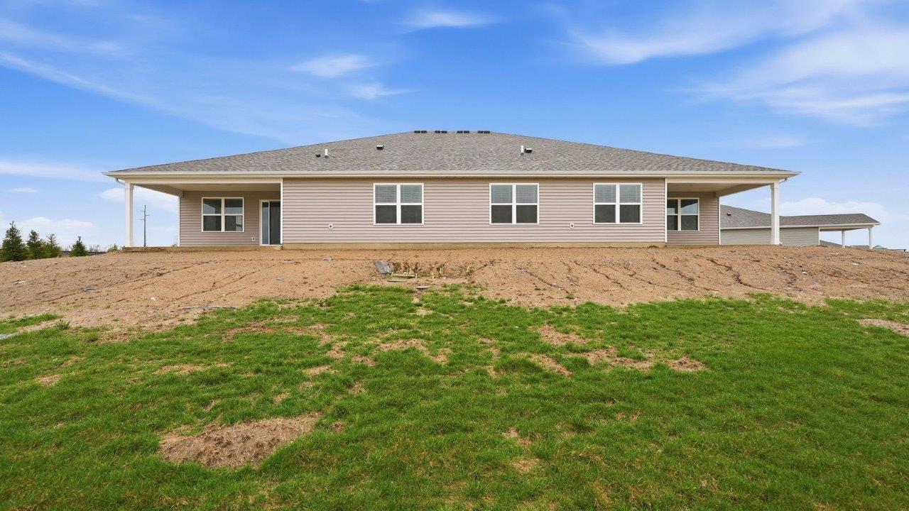 rear exterior with covered patio and pond view