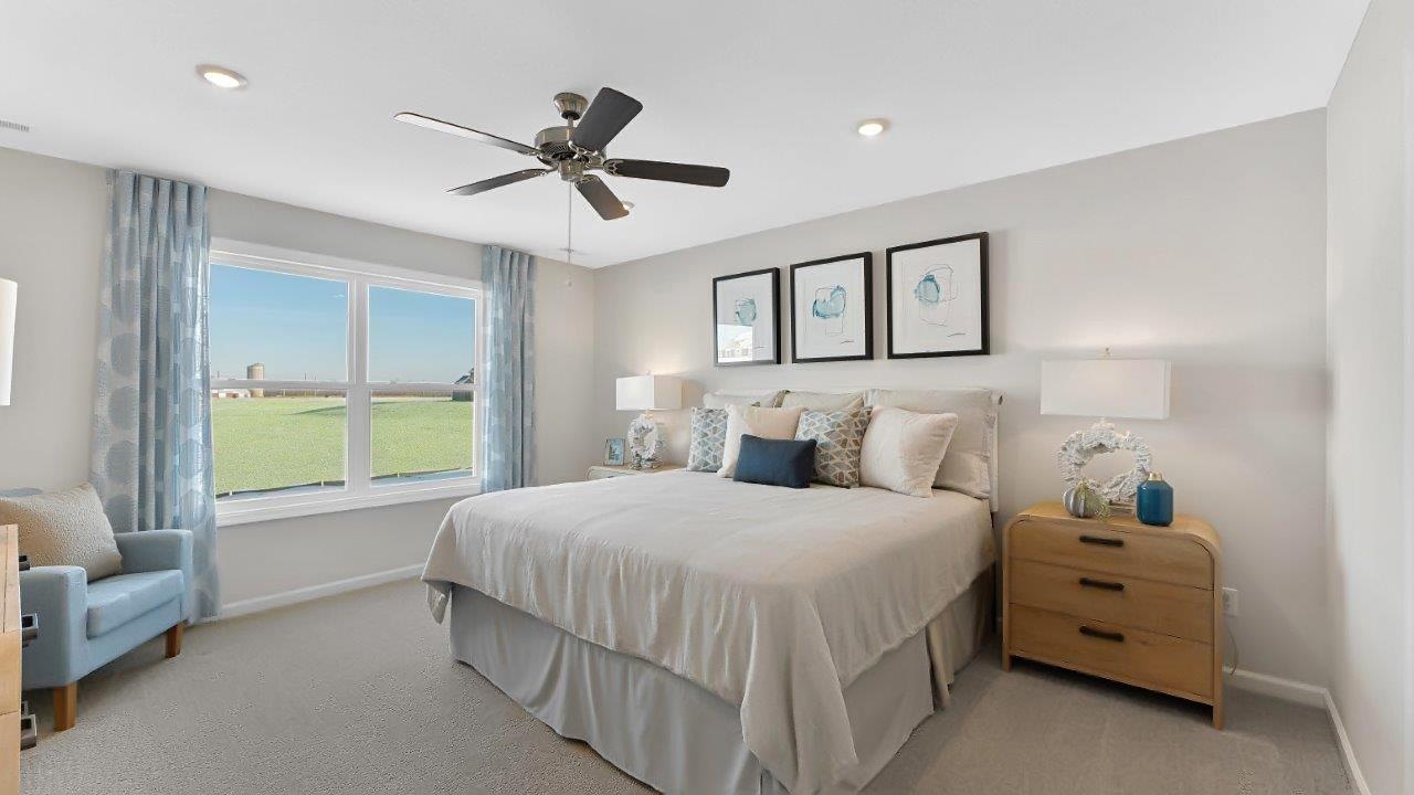 erie primary bedroom with carpet, fan, and natural lighting