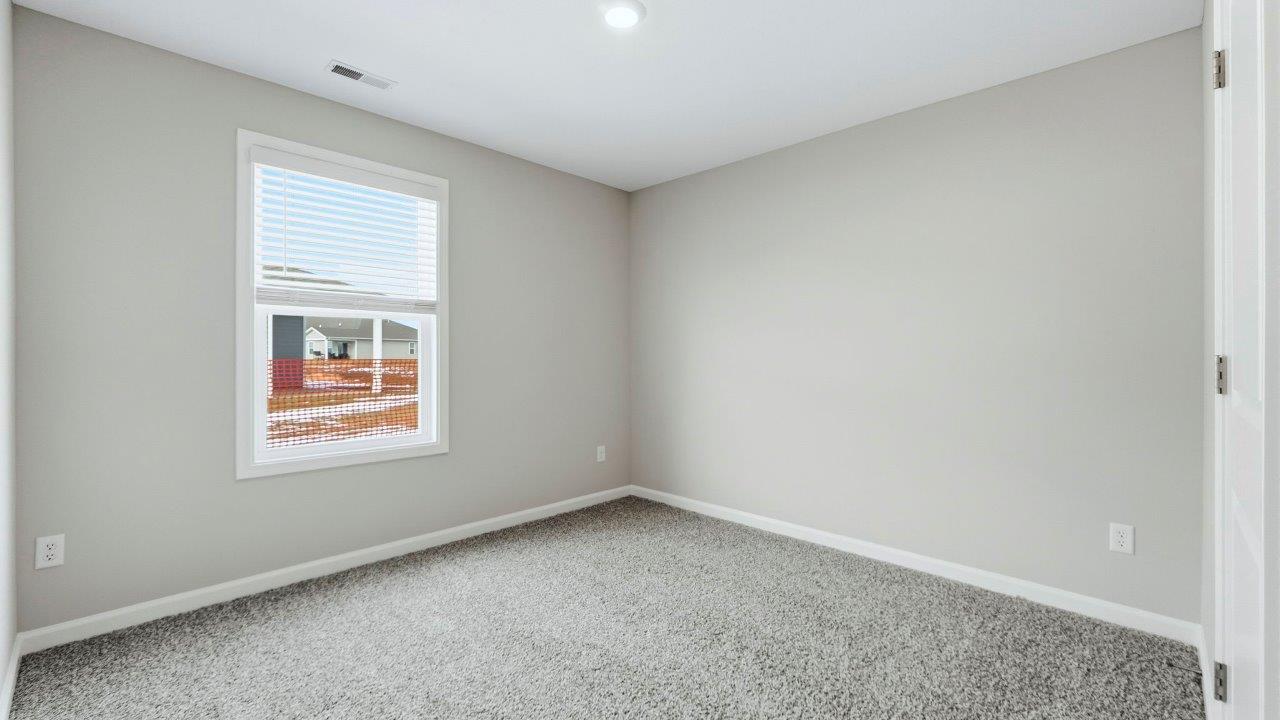 bedroom 3 with carpet flooring, 1 window, and closet