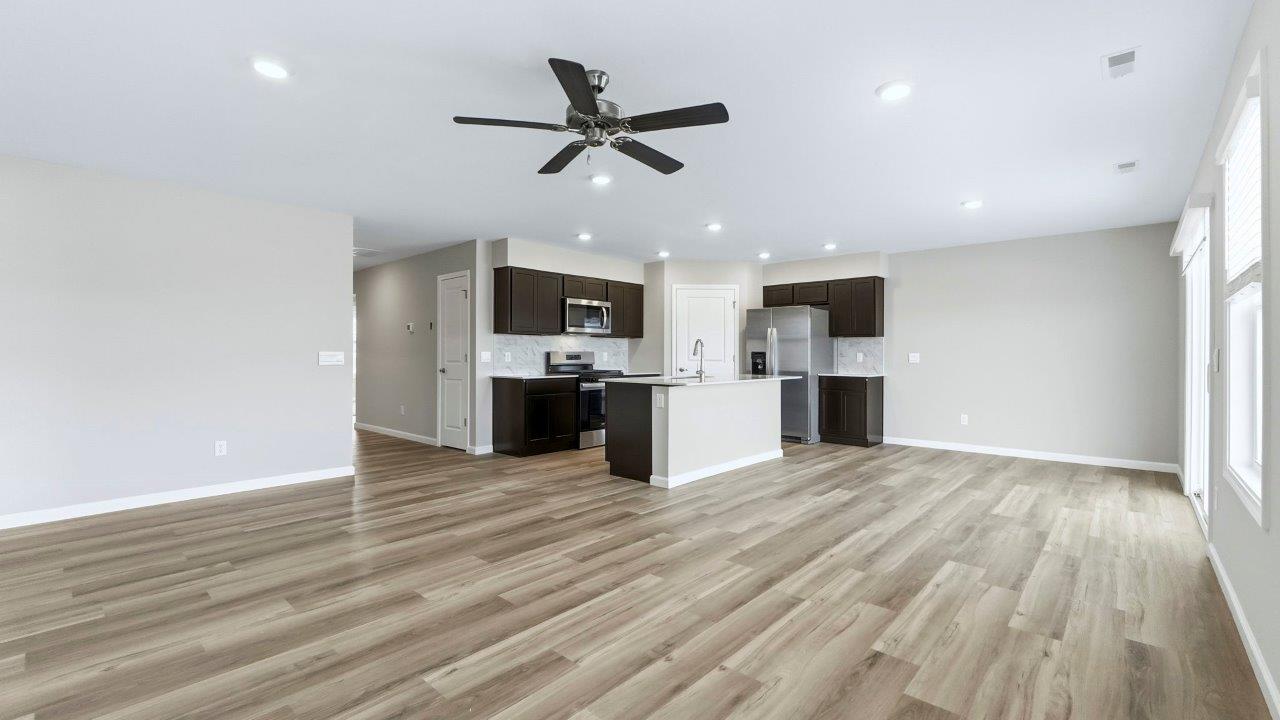 living room with mohawk avery lvp, natural lighting, popular grey walls, and ceiling fan