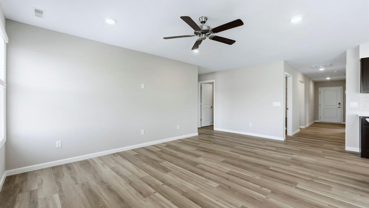living room with mohawk avery lvp, natural lighting, popular grey walls, and ceiling fan