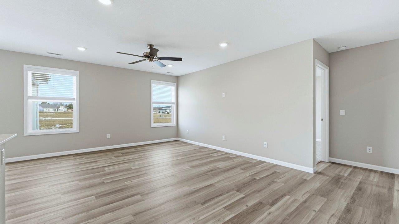 living room with mohawk avery lvp, natural lighting, popular grey walls, and ceiling fan