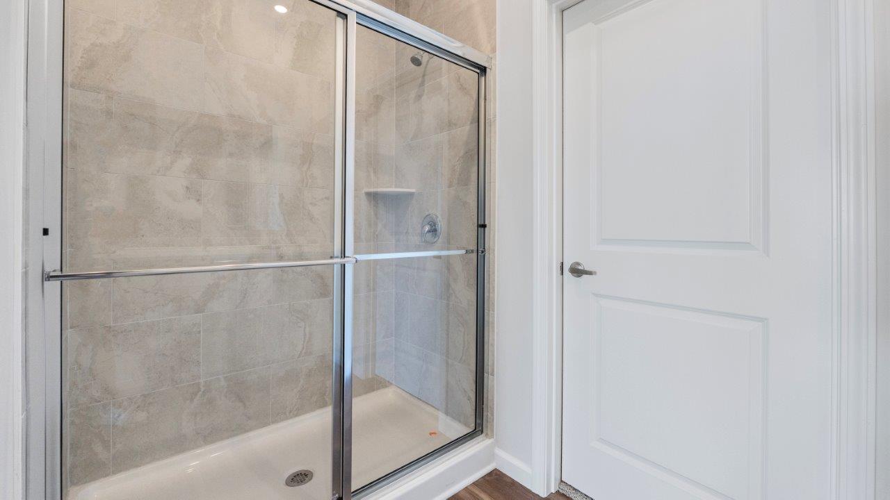 kennebec paired villa erie primary bedroom ensuite bath with tile shower