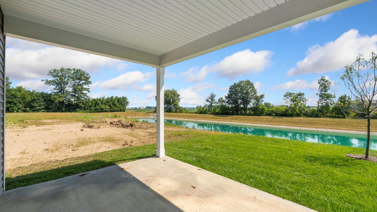 kennebec paired villa erie rear exterior with covered patio overlooking pond