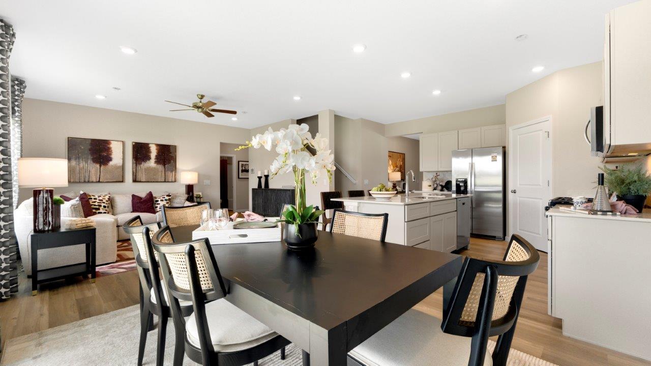casual dining space with lvp flooring and sliding door to backyard patio