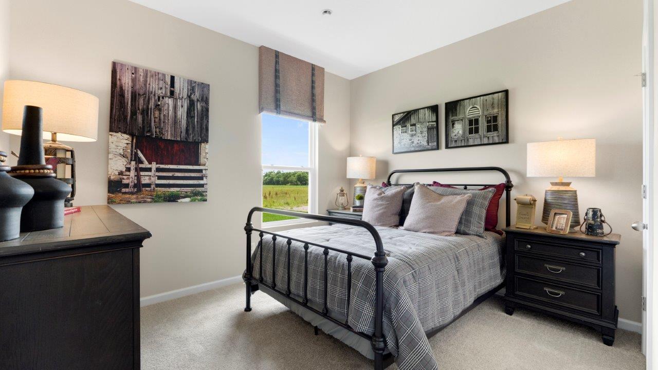 first floor guest bedroom 5 with carpet flooring