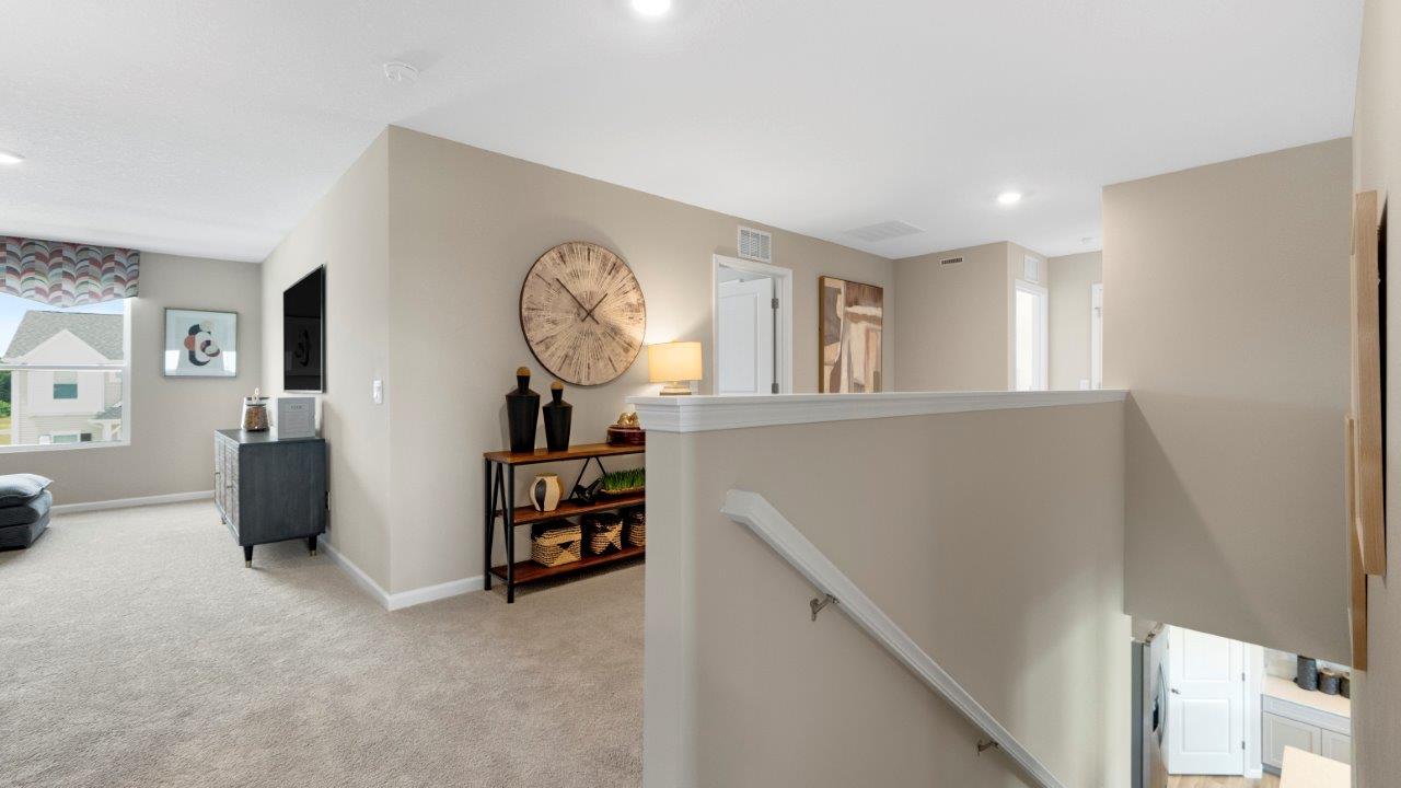second floor stair landing with carpet flooring