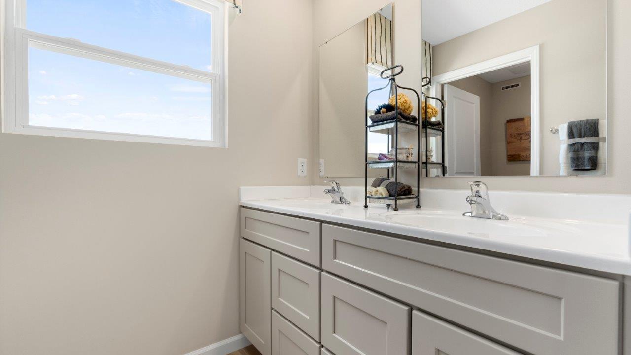 full bathroom with dual sink vanity and tub shower