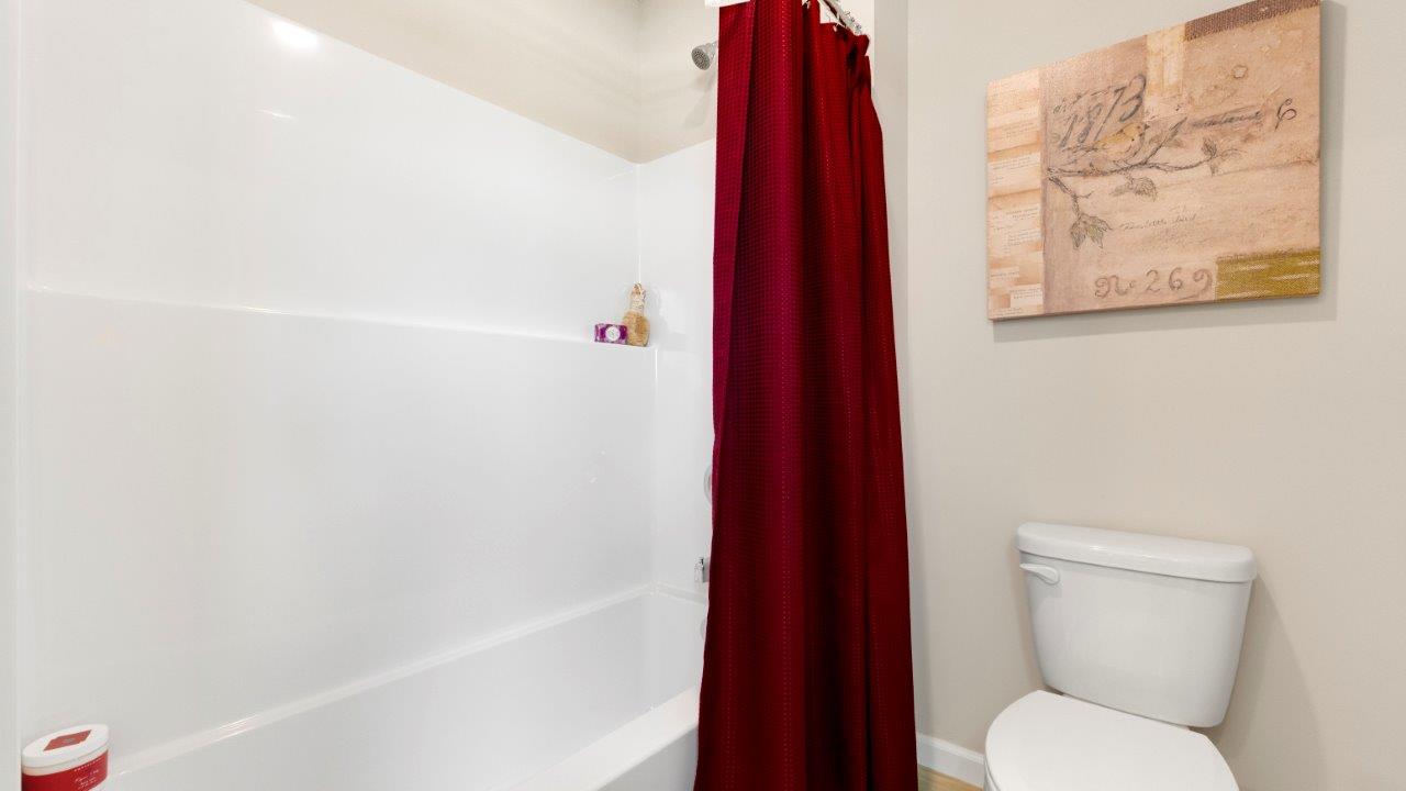 full bathroom with dual sink vanity and tub shower