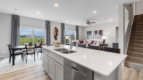 belmont woods henley kitchen with lvp, large island, stainless steel, and large pantry