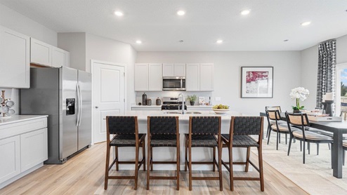 belmont woods henley kitchen with lvp, large island, stainless steel, and large pantry