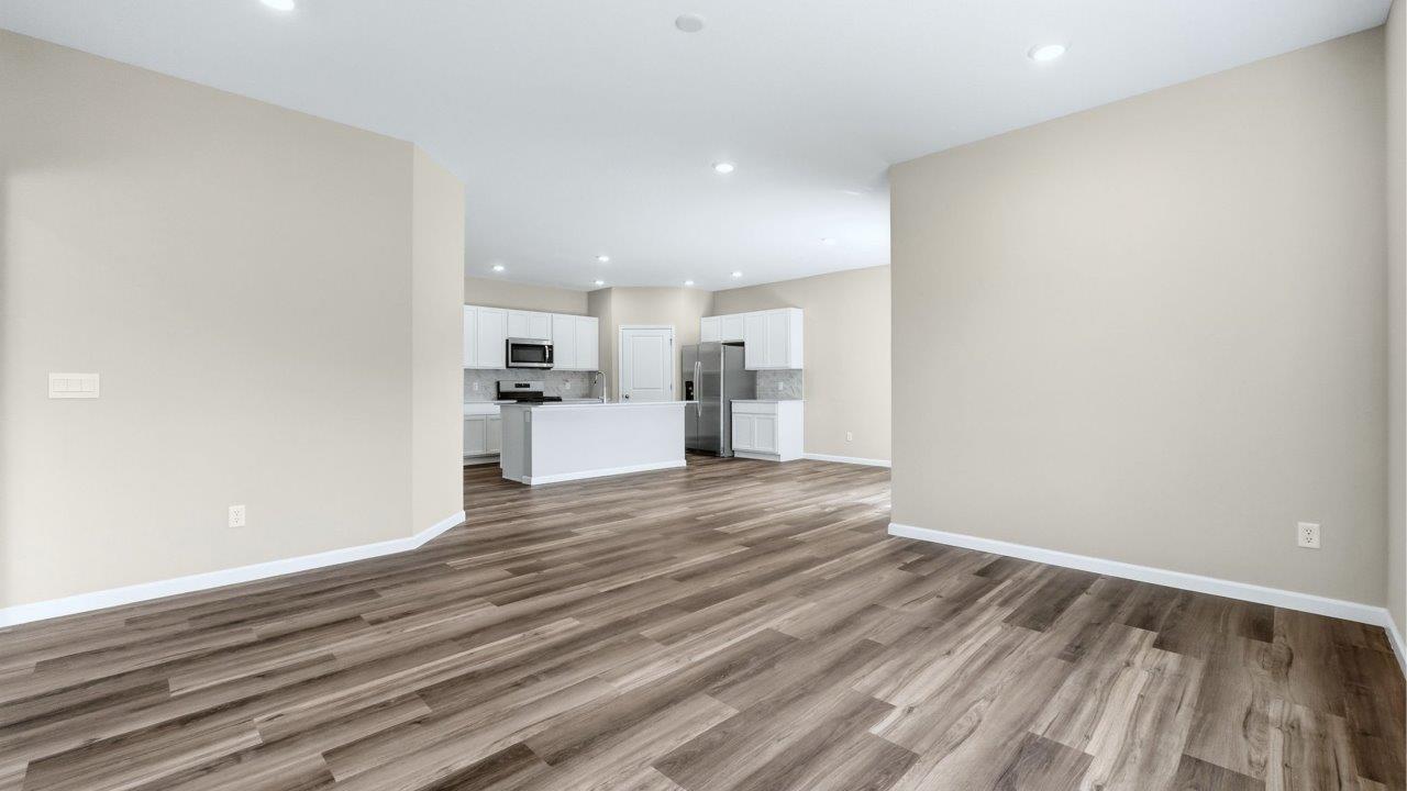 living room in open plan with lvp flooring and popular grey walls