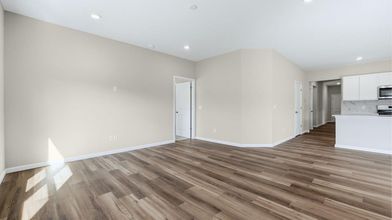 living room in open plan with lvp flooring and popular grey walls