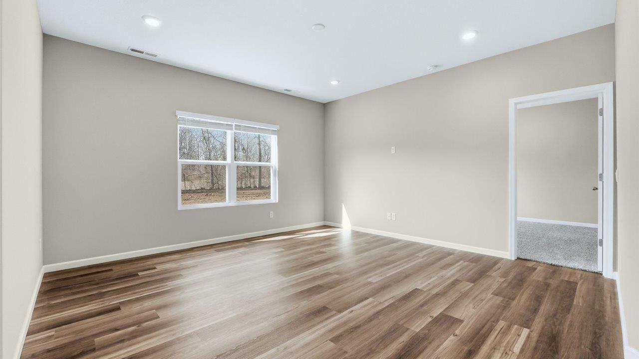 living room in open plan with lvp flooring and popular grey walls