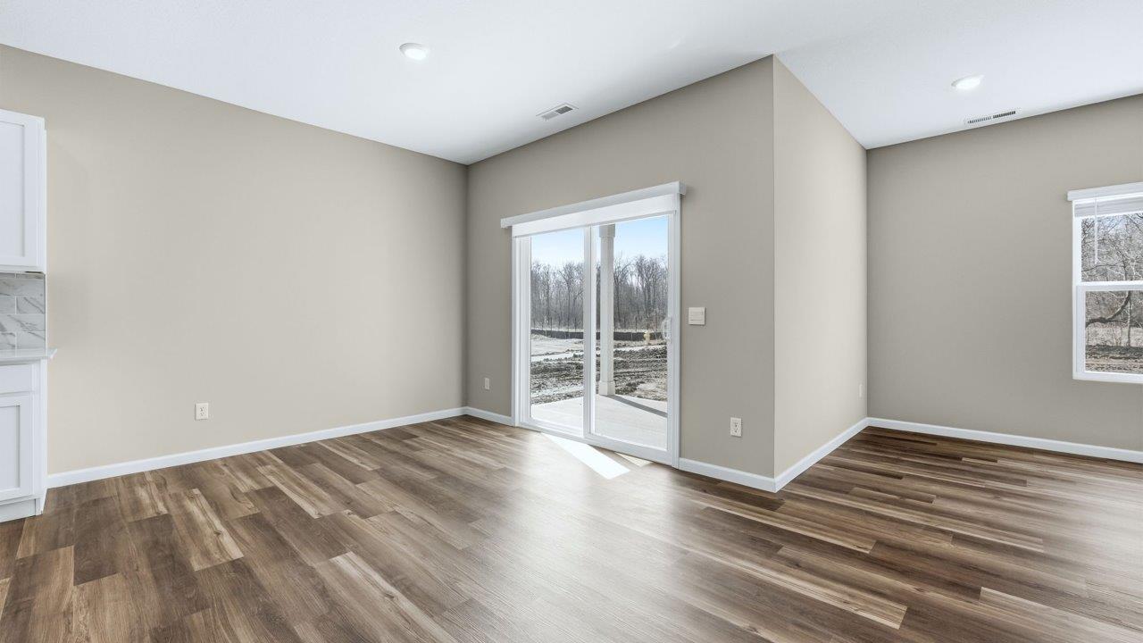 dining room with lvp flooring and sliding glass door to backyard patio
