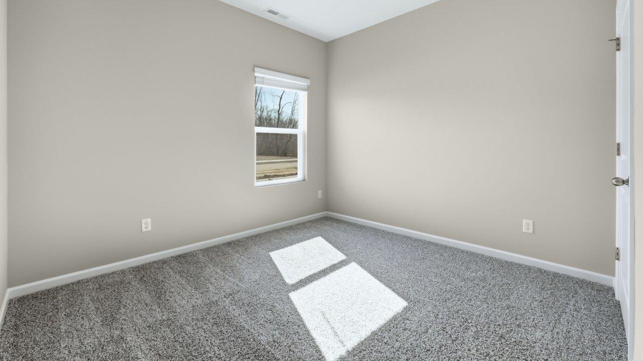 bedroom 3 with carpet flooring, popular grey walls, and ensuite closet