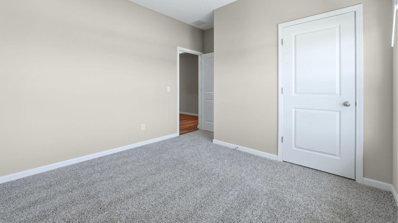 bedroom 4 with carpet flooring, popular grey walls, and ensuite closet