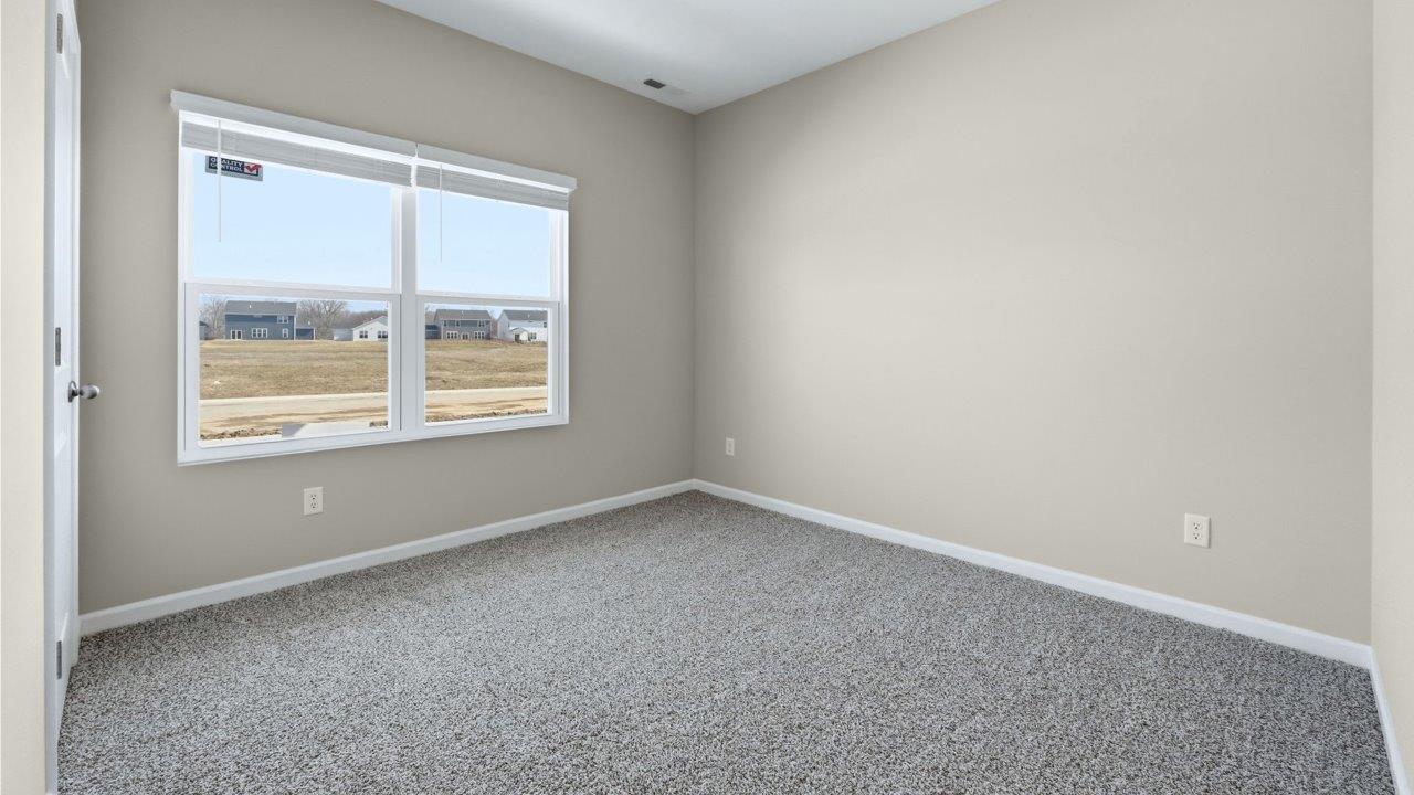 bedroom 4 with carpet flooring, popular grey walls, and ensuite closet