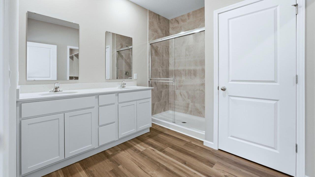 primary ensuite bathroom with dual vanity sinks/shower