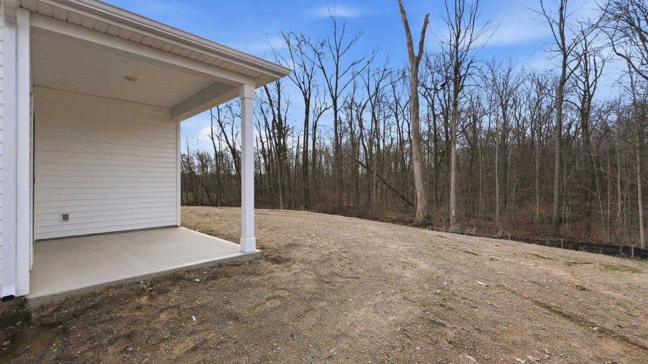 rear exterior with covered porch and tree lined yard