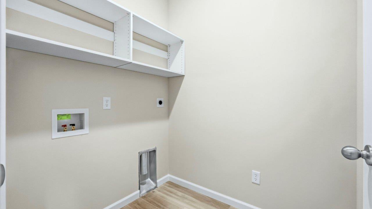 laundry room with lvp flooring and built in shelving