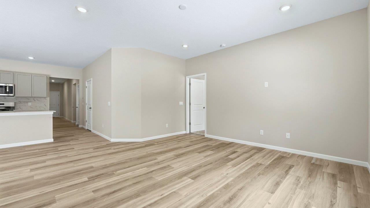 living room open plan with LVP flooring, 2 windows, and popular grey walls