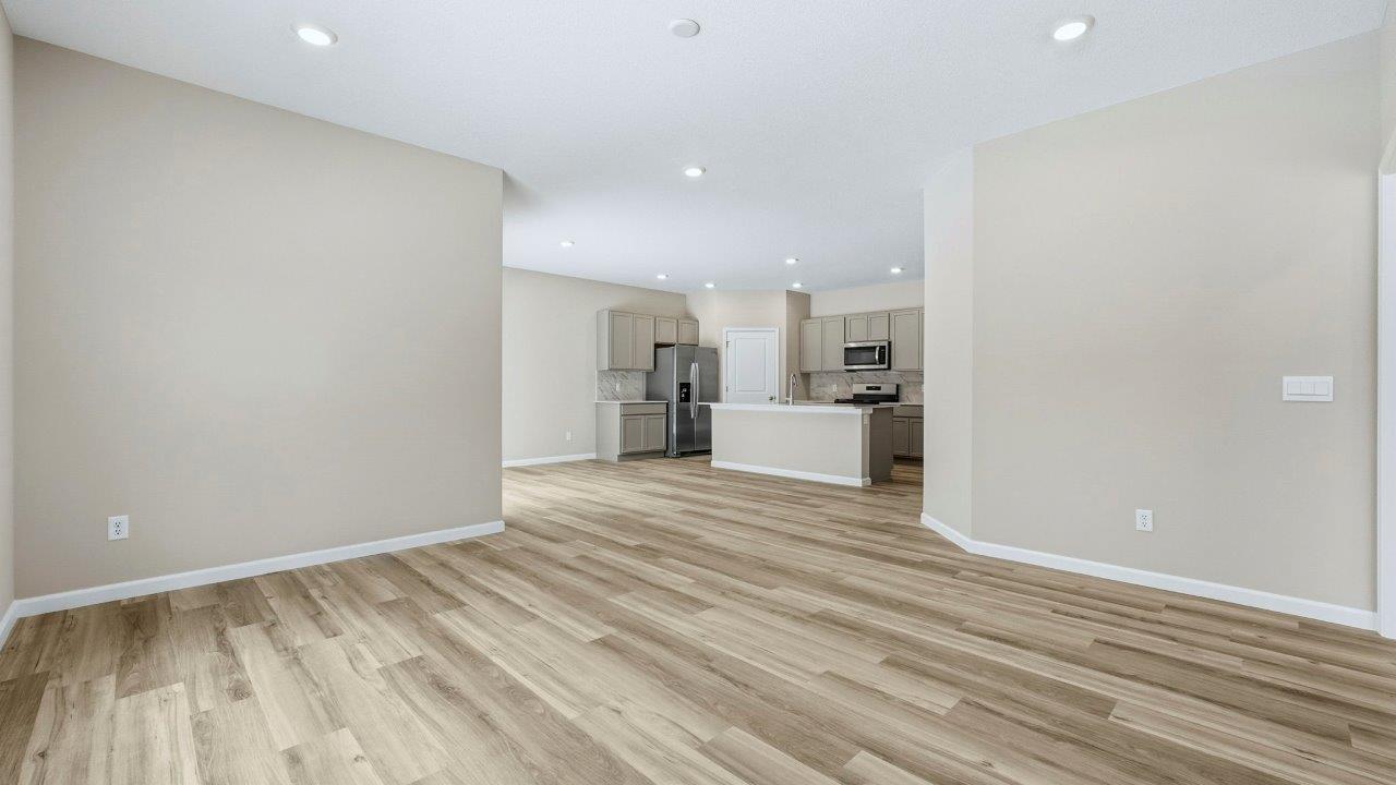 living room open plan with LVP flooring, 2 windows, and popular grey walls