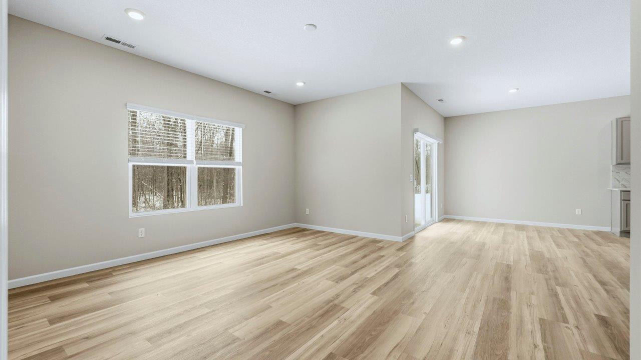living room open plan with LVP flooring, 2 windows, and popular grey walls