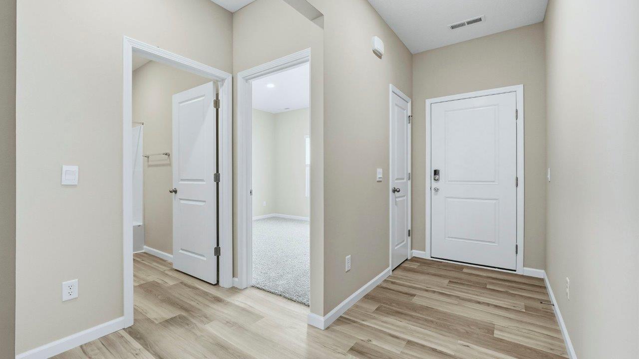 foyer with Mohawk Avery LVP flooring and popular grey walls.