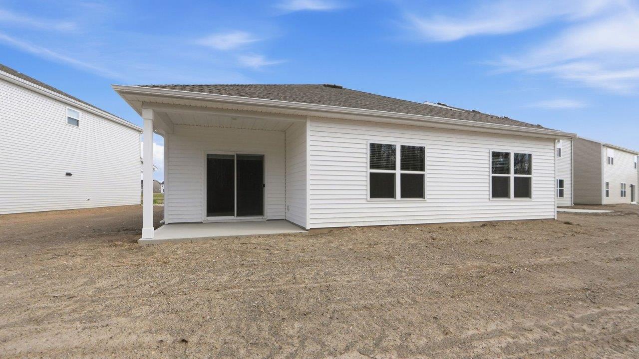 rear exterior with covered porch and tree lined yard
