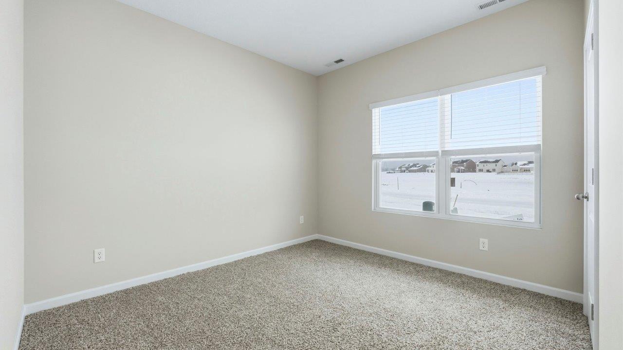 bedroom 2 with carpet, closet, and two windows