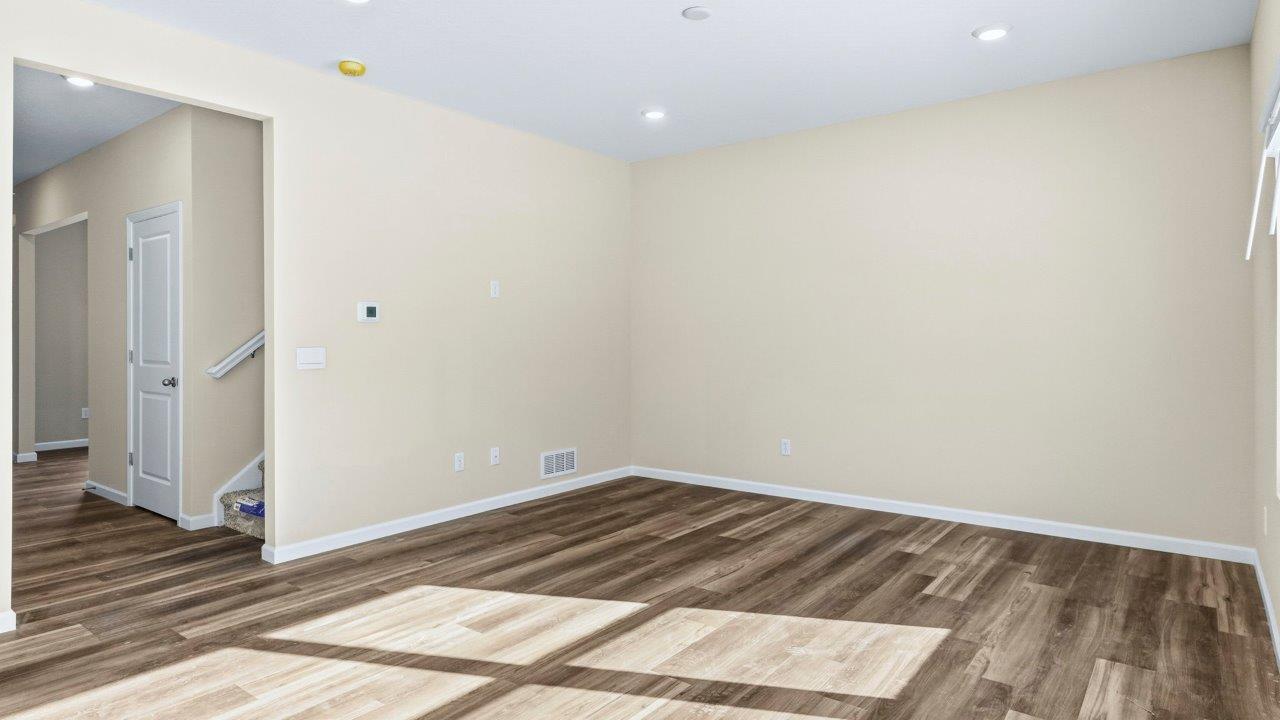 living room with Mohawk Eastmont flooring and many windows for natural lighting